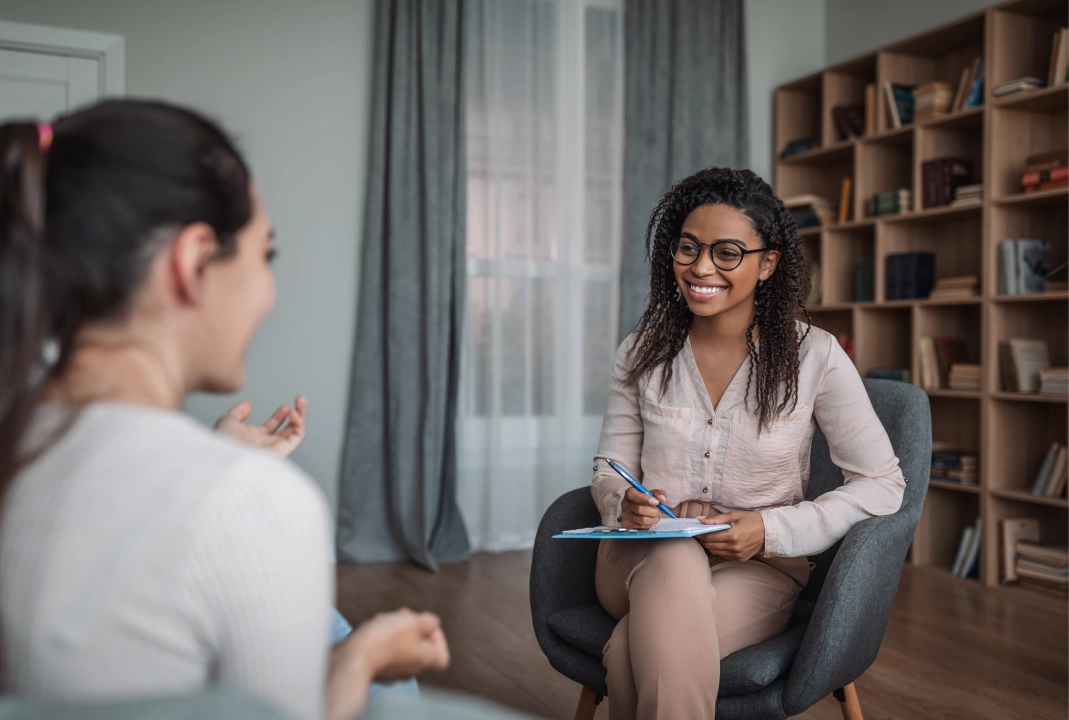 Woman in glasses talking to client.